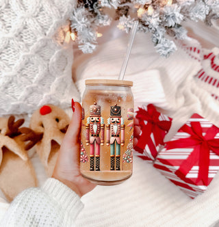 Sparkly Christmas coffee tumbler – boho Nutcracker soldiers and tree design
Holiday coffee bar decor – glass cup with Christmas tree, bow, floral accents, and glitter