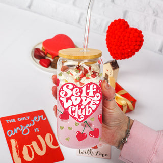 Wholesale 20oz glass cups with bamboo lid and glass straw featuring red heart and cherry graphics, ideal for Galentine’s Day gifts.
Empowering wholesale 20oz glass cups with bamboo lid, glass straw, and Self Love Club design for women’s gifts.