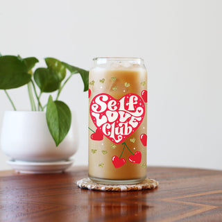 Vintage-style 20oz glass cups with bamboo lid, glass straw, and red heart cherry graphic for a modern twist.
Playful "Self Love Club" 20oz glass cups with bamboo lid, glass straw, and gold glitter accents.
20oz glass cups with bamboo lid and glass straw, featuring retro "Self Love Club" and red heart cherry design.