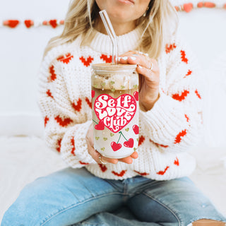 Wholesale 20oz glass cups with bamboo lid and glass straw featuring gold glitter hearts and motivational Self Love Club message.
Self Love Club wholesale 20oz glass cups with bamboo lid and glass straw for women’s self growth and empowerment.