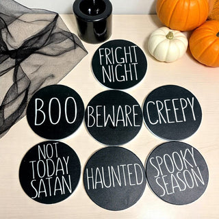 Individual Halloween coaster showing cork backing detail
Halloween party table setting with themed coasters
Close-up of Halloween coaster text and design