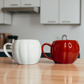 Fall kitchen decor - ceramic pumpkin shaped coffee mugs for Halloween home styling
Seasonal home accessories - white and rust orange pumpkin coffee mugs for fall decorating