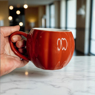 Rust Orange Pumpkin Mug with Cinnamon Sticks and Fall Leaves
Cozy Fall Morning with Pumpkin Shaped Coffee Cup