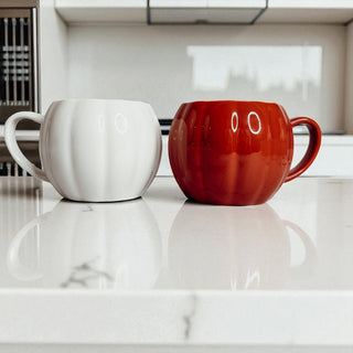 Artisan pumpkin coffee mugs - fall themed ceramic cups for seasonal entertaining
Halloween pumpkin shaped drinkware - white and rust ceramic coffee mugs