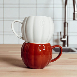 Seasonal pumpkin shaped ceramic mugs - fall home decor accessories and Halloween kitchen items
Handcrafted pumpkin coffee cups in white and orange - unique fall gifts and Halloween decor