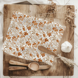 flour sack cotton fall dish towel hanging on stove
autumn leaves hand towel 
rustic fall kitchen decor towel with leaves
white cotton towel with orange and tan leaf pattern
fall themed flour sack towel for dish drying
cozy autumn kitchen towel with leafy design