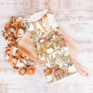 fall rabbit kitchen towel beside wooden spoon and herbs
storybook bunny and pumpkin design flour sack towel
neutral autumn bunny towel for farmhouse fall décor
autumn bunny dish towel layered with plaid hand towel in kitchen