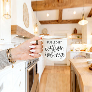 burnout humor fueled by caffeine mug
office humor coffee cup fueled by caffeine and mild rage
large ceramic mug for caffeine lovers
funny mug for overworked coworkers
fueled by caffeine and mild rage script mug close up
modern black script caffeine quote mug