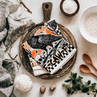 edgy fall kitchen towel with crow skull and checkered border
funny fall tea towel for halloween parties crow design
black bird halloween hand towel with orange grunge background
crow and jack o lantern style skull towel for spooky décor
all hallows eve gothic crow towel for autumn décor