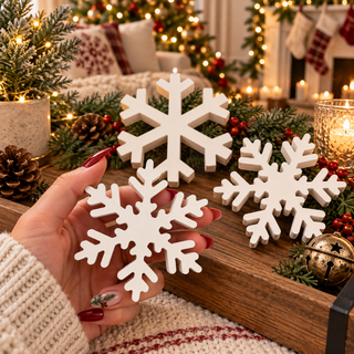 Festive winter tabletop display with assorted snowflakes
Christmas console table décor with white snowflake accents
White snowflake figurines displayed with candles and greenery