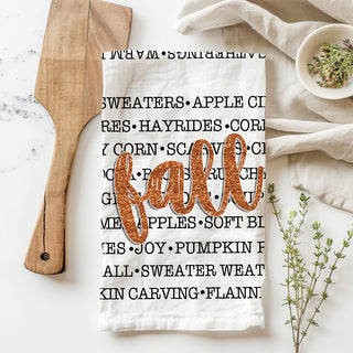 autumn kitchen accessory with black word art and orange script
fall word list towel used as bread basket liner
seasonal hostess gift fall typography dish towel
cozy entryway display with framed art and fall words towel