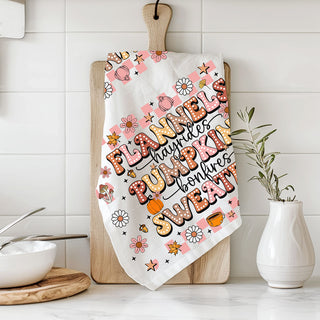autumn kitchen décor towel with flannels and pumpkins text
pink pumpkin spice kitchen towel for sweater weather lovers
fall tea towel with cute daisies coffee cups and pumpkins
retro fall words dish towel hanging on oven handle
pink fall kitchen accessory towel for seasonal shelf styling