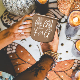 hello fall script mug with dried florals
hello fall mug beside rustic fall centerpiece
hello fall coffee mug with open book and glasses
hello fall mug on couch with knit blanket