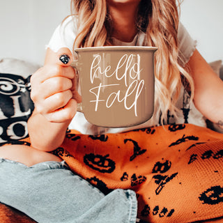 hello fall coffee mug with neutral fall decor
hello fall mug next to carved pumpkin and lantern
hello fall coffee mug held in hands
hello fall mug close up product shot
hello fall autumn mug with cozy candle wholesalers