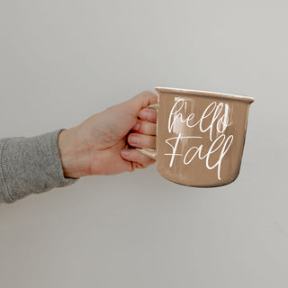 hello fall autumn drinkware in cozy living room
hello fall mug with gold spoon and saucer
hello fall mug on window sill with rainy day view
hello fall mug by fireplace with stacked wood
hello fall mug next to pumpkin bread loaf
hello fall mug as part of autumn self care setup