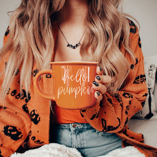 fall coffee mug styled with chunky knit cardigan
hello pumpkin mug for cozy sweater weather mornings
autumn coffee cup in warm orange color