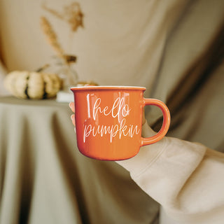 orange mug with steam and fall decor
fall hot drink mug with pumpkins and leaves
rustic orange coffee mug on wooden tray
pumpkin colored mug for cozy nights in