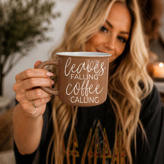 fall gift mug with leaves falling coffee calling saying
autumn leaves themed coffee mug on countertop
brown ceramic fall mug for pumpkin spice and coffee
leaves falling coffee calling mug with mini white pumpkins
autumn coffee bar decor with brown leaves falling mug