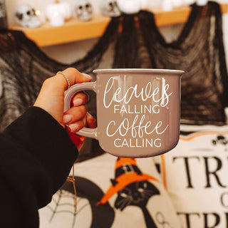 fall gift box including brown leaves falling coffee calling mug
neutral fall decor with brown coffee cup centerpiece
leaves falling coffee calling mug in modern farmhouse hutch
autumn styled shelf with brown quote mug and pumpkins