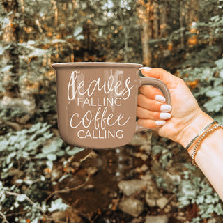 brown fall coffee cup on marble with scattered leaves
leaves falling coffee calling mug for fall hostess gift
autumn breakfast spread with brown coffee mug and pastries
brown fall mug next to coffee beans and pumpkin decor