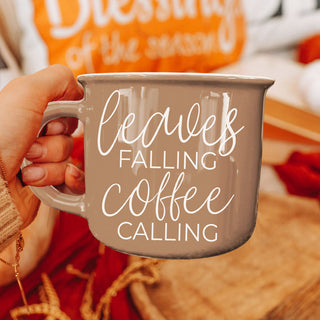 leaves falling coffee calling mug used as fall kitchen accent
cozy autumn corner with chair blanket and brown coffee mug
fall inspired flatlay featuring brown quote mug and foliage
brown ceramic autumn mug in boho style kitchen
leaves falling coffee calling mug paired with fall dish towel