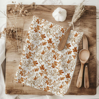 flour sack cotton fall dish towel hanging on stove
autumn leaves hand towel 
rustic fall kitchen decor towel with leaves
white cotton towel with orange and tan leaf pattern
fall themed flour sack towel for dish drying
cozy autumn kitchen towel with leafy design