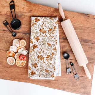 autumn leaves flour sack towel
fall kitchen decor towel on oven handle
autumn leaf print towel 
brown and copper leaf fall dish towel 
soft cotton fall towel for drying dishes and hands
seasonal autumn kitchen towel for thanksgiving baking