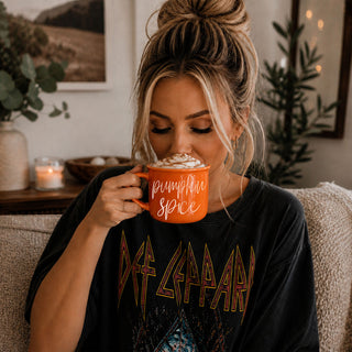 halloween and fall style drinkware for seasonal sippers
autumn girls night in scene with snacks and coffee mug
fall themed gift bundle with mug and treats
spooky season coffee mug for october