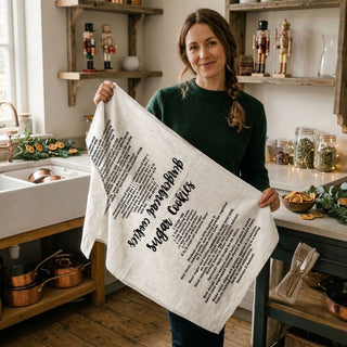 christmas kitchen towel held by woman cozy home
holiday towel lifestyle outdoor christmas scene
kitchen towel with recipe in front of christmas tree
festive towel styled with holiday decor lights
cozy christmas kitchen towel lifestyle aesthetic