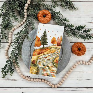 harvest season kitchen towel with patchwork hill and trees
fall farmhouse towel with scenic road and golden leaves
woodland autumn path tea towel for rustic cabin kitchen
fall baking towel with quilt pattern path and trees