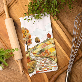 farmhouse fall décor towel draped over oven handle
unique patchwork landscape towel for fall coffee bar styling
vintage autumn home accent towel with rolling hills and trees