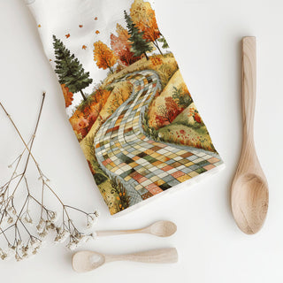 Cozy autumn charm to your home with this patchwork road fall kitchen towel. Featuring a winding quilt-style path through colorful fall trees and leaves, this soft, absorbent flour sack cotton towel is perfect as a fall dish towel, tea towel or hand towel. A beautiful farmhouse autumn kitchen décor accent and thoughtful