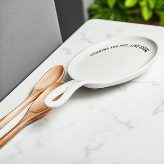 White ceramic spoon rest with cursive Stirring the Pot quote
Black ceramic spoon rest with bold Stirring the Pot text