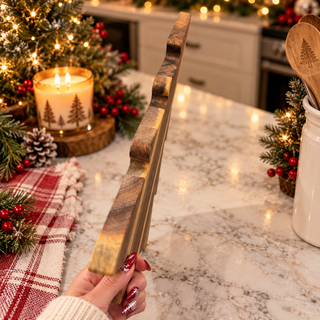 Christmas tree charcuterie board in a cozy holiday kitchen setting
Acacia wood serving board styled for Christmas entertaining
Rustic Christmas kitchen with a wooden tree-shaped serving board
Christmas tree cutting board displayed on a festive holiday table
Holiday charcuterie board surrounded by evergreen branches and lights