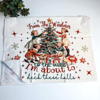flour sack towel with "deck these halls" christmas quote
vintage christmas decor towel with kids and tree graphic
from the windows to the walls christmas towel