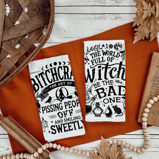 sarcastic witchy style to your kitchen with this funny Halloween towel. One side reads “In a world full of witches be the bad one” and the other says “Bitchcraft – the art of pissing people off and smiling sweetly.” Printed in black on soft, absorbent flour sack cotton, this humorous witch kitchen towel is perfect for Halloween décor, witchcore kitchens, hostess gifts and funny gifts for snarky friends who love spooky season.